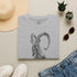 The Krikri graphic tee featuring a bold illustration of the iconic Kri-Kri goat on a T-shirt.